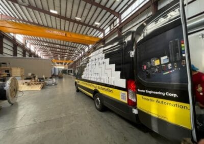 Gallery 63 Automated Dynamics Corp. mobile automation vehicle inside industrial warehouse with equipment and a.