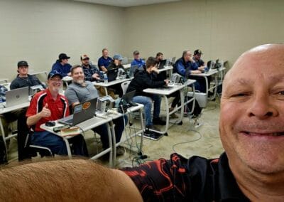 Gallery 70 Group of people attending a computer training session in a classroom setting.
