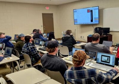 Gallery 72 Students in a classroom using laptops for a digital skills training session.