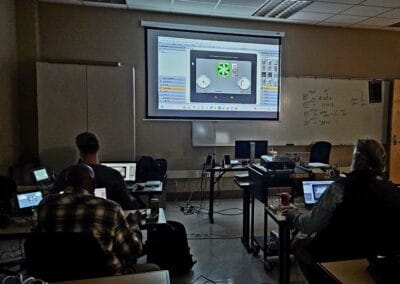 Gallery 75 Classroom with students watching a presentation on a large screen about automation and control.
