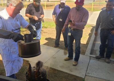 Gallery 90 Demonstration of industrial equipment at Automated Dynamics Corp. with team observing.