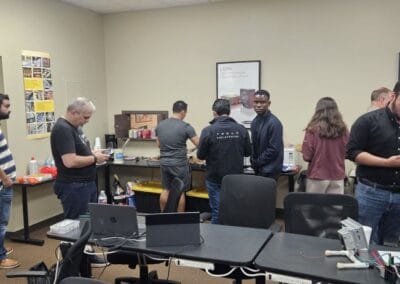 Gallery 103 Business meeting at Automated Dynamics Corp. office with employees collaborating.