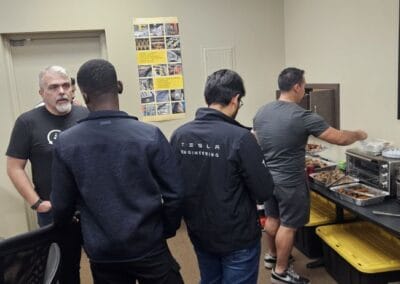 Gallery 104 Group of people in a tech workshop or training session at Automated Dynamics Corp.