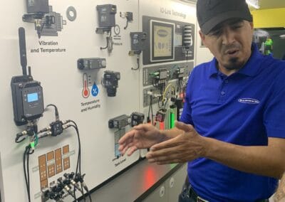 Gallery 48 Automated Dynamics Corp. technician explaining condition monitoring solutions with sensors and data.