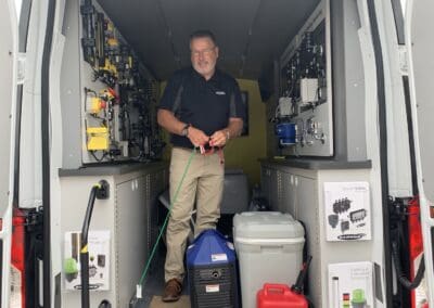 Gallery 52 Technician inside a service van with electrical equipment and tools for automation systems.