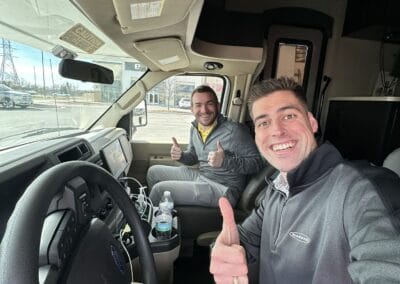 Gallery 59 Two smiling men inside a truck cab giving thumbs up, promoting Automated Dynamics Corp.