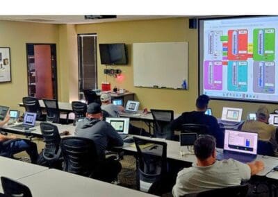 Gallery 7 Classroom with students using tablets and a large digital display showing a flowchart.