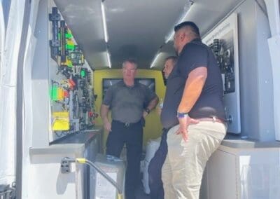 Gallery 64 Technicians inspecting equipment inside a mobile service van at Automated Dynamics Corp.